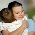 iStock - mom hugging her son tightly 2