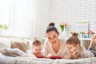babysitter reading to two children