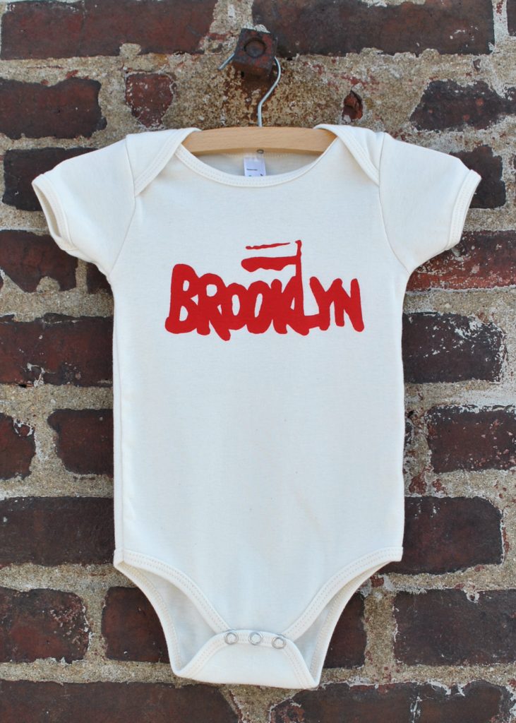 baby onsie made is Brooklyn, white with red lettering that says Brooklyn 