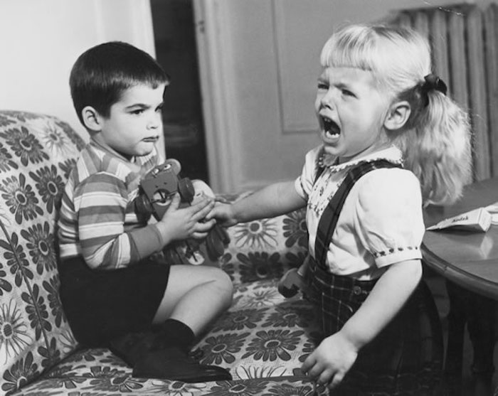 siblings fighting over toy