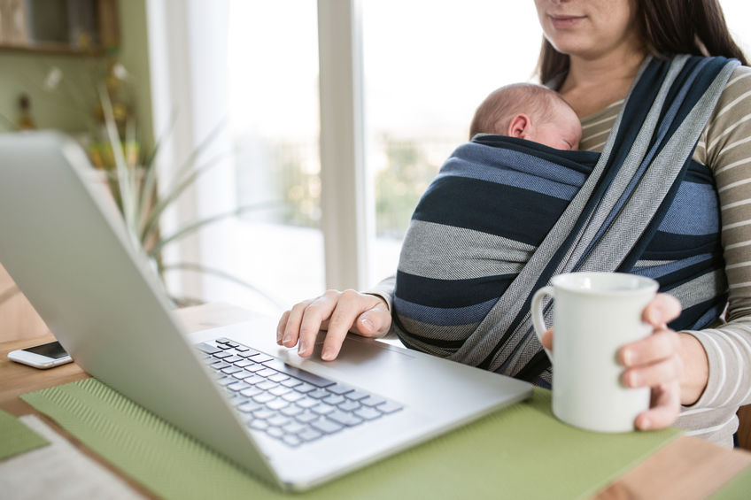 mom at computer with baby in sling