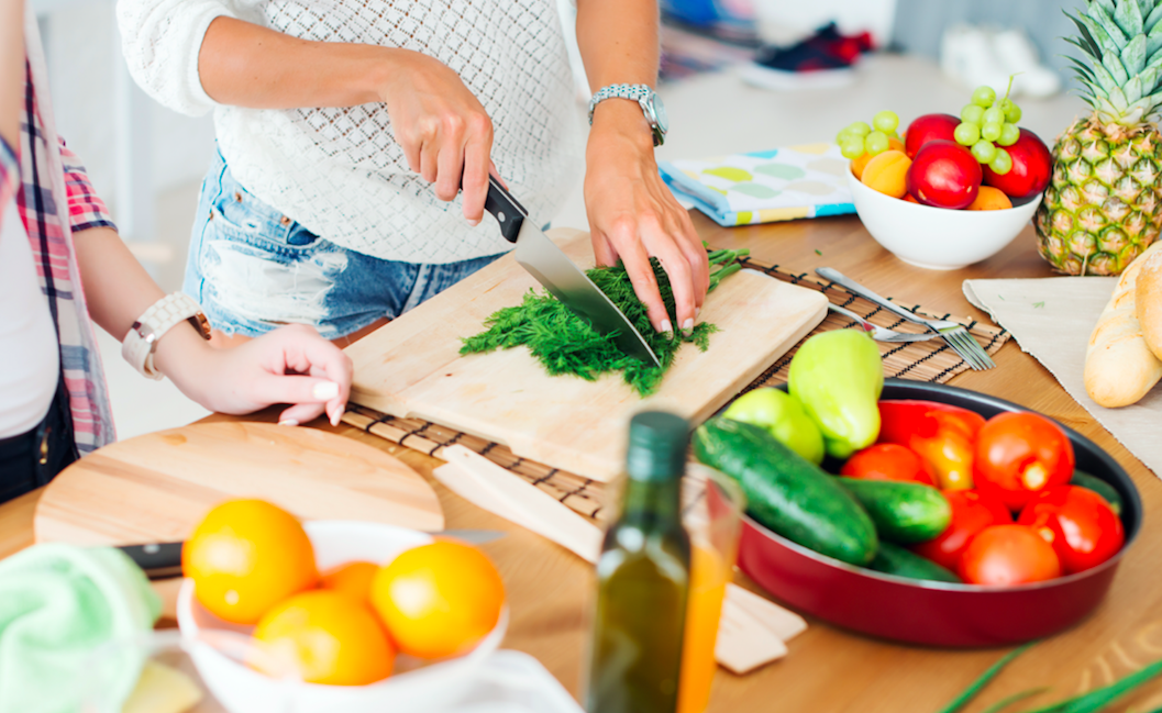 healthy food orange olive oil knife kitchen dinner counter cutting board groceries arm woman cooking prep