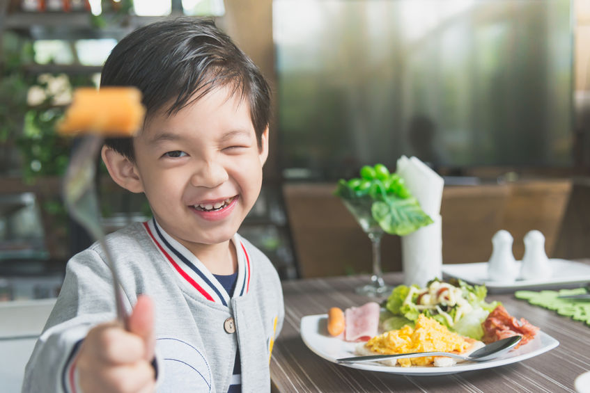 Asian child eating breakfast - Mommybites New York