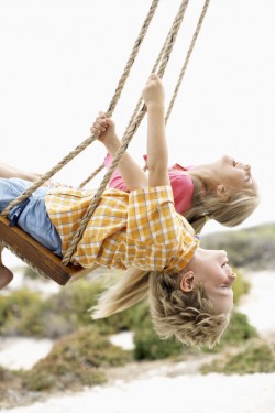 Kids playtime swinging on swings, social time for kids at school