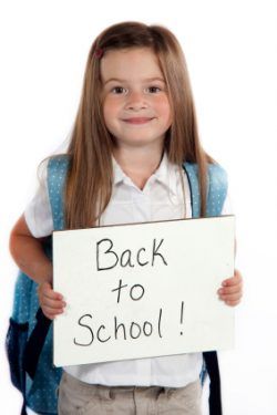 iStock - girl with back to school sign (2)