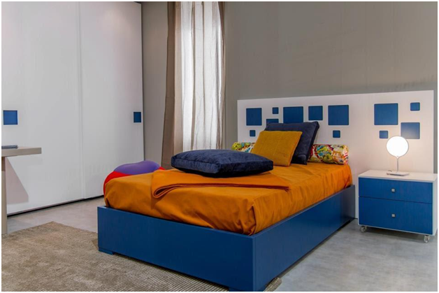 orange sheets on blue bed