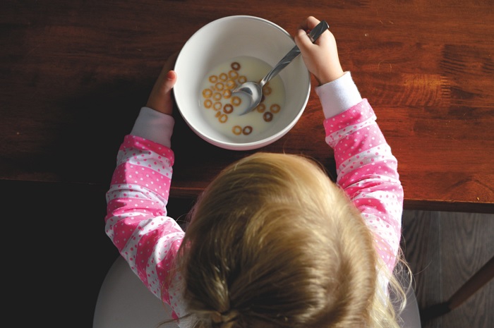 kid, eating, picky eater, strategies for picky eaters, cereal, child, white, pink, silver, spoon, milk