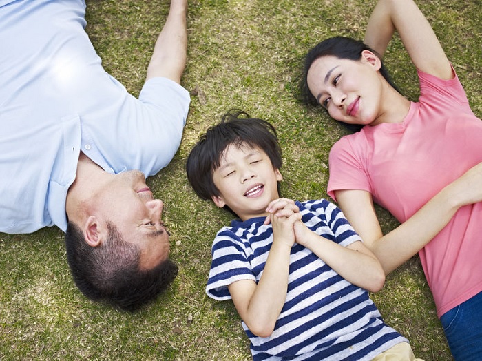 mindful parenting, parenting, asian family, family, family lying on grass