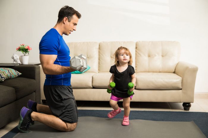 weights, dumbbells, exercise, dad, daughter, sneakers, athletics, blue, black, pink, green, couch, living room, workout 