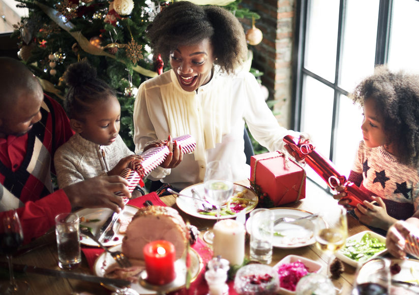 family, christmas, holiday, dinner, meal, gifts, presents, brunette, tree, christmas tree, happy, smile, ornaments, candles, green, white, red, wrapping paper, children, mom, daughter, father, mother, parents, glass, food, water, meat, window, brick, exposed brick