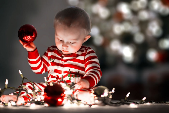 baby with christmas decorations, red, christmas ornaments, seasonal safety, holidays, christmas lights