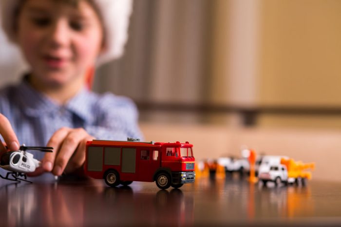 boy, kid, child, play, playing, toy, toys, truck, helicopter, santa hat, figures, table, holiday