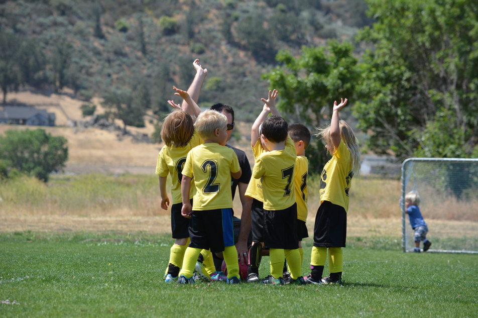 Children, boys, girls, sports, soccer, outdoors, jerseys, uniform, field, goal, yellow, numbers, team, black, green