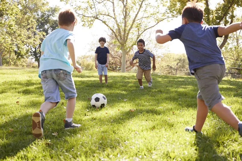 boys playing soccer in the sunshine