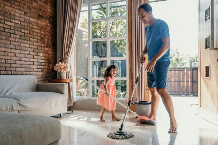 family cleaning floor with non toxic cleaning products