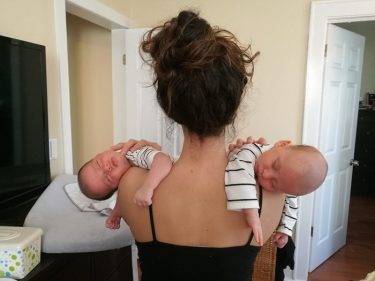 holding sleeping twins