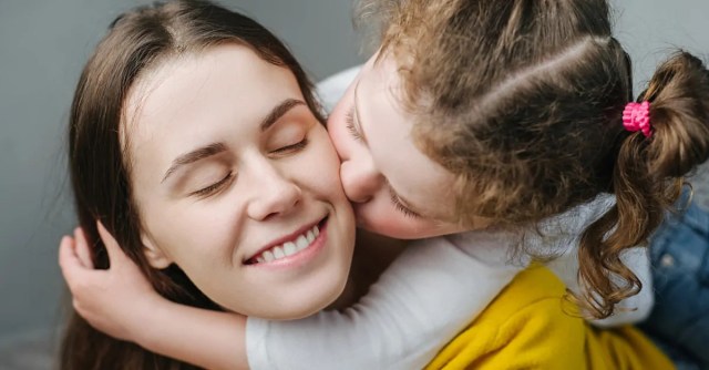 girl kissing her nanny