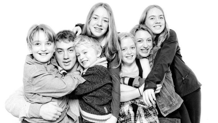 family of seven embracing