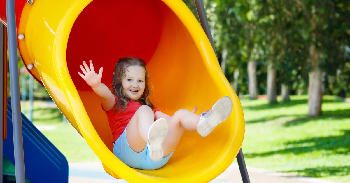 child playing on a slide
