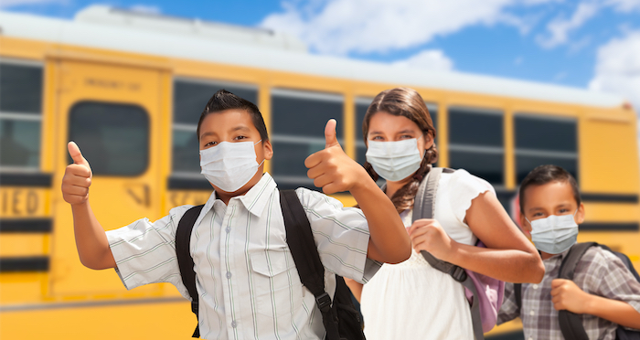 kids in mask with school bus