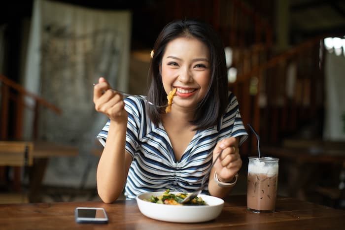 woman eating and smiling