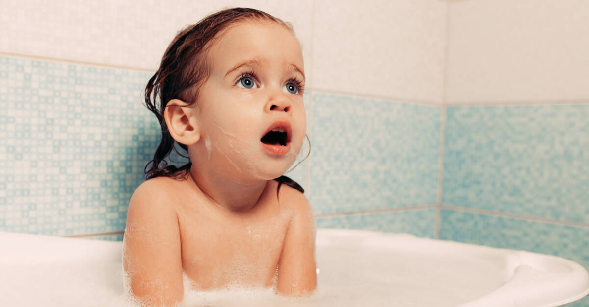 toddler girl taking bath