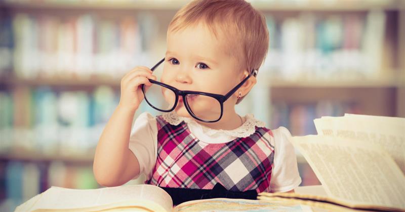 toddler with glasses in library 