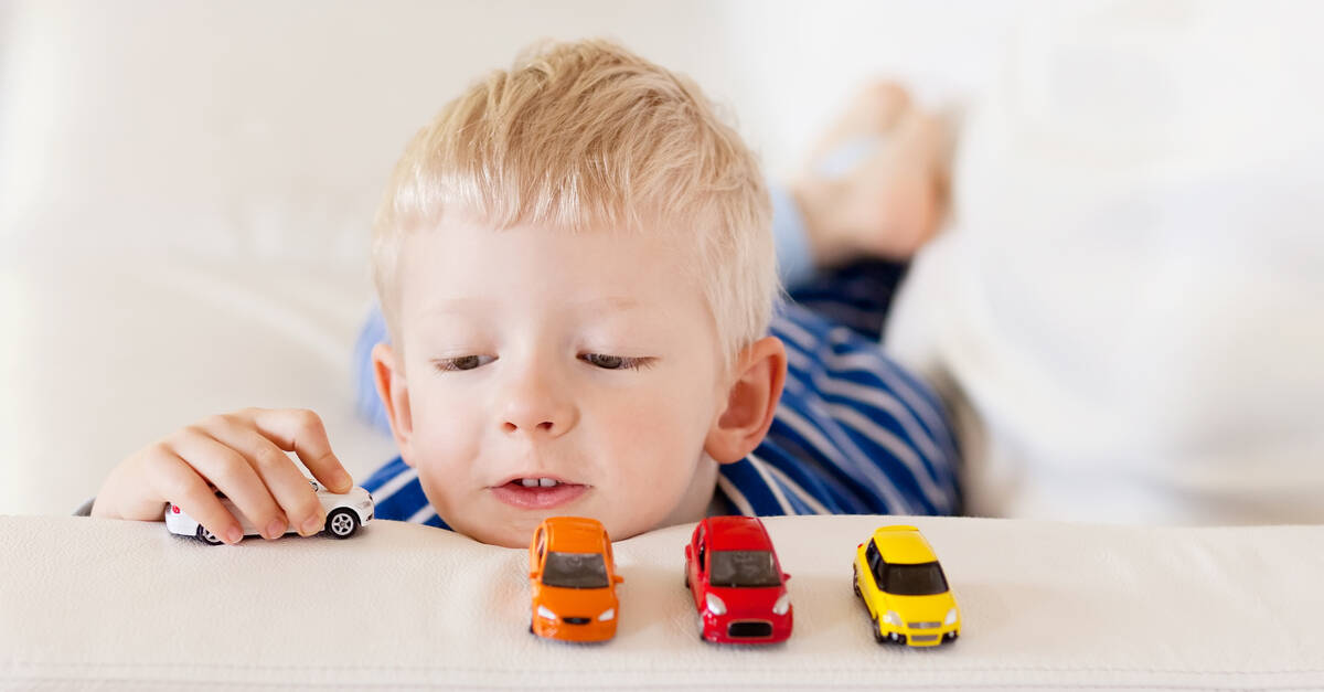 boy playing with matchbox cars