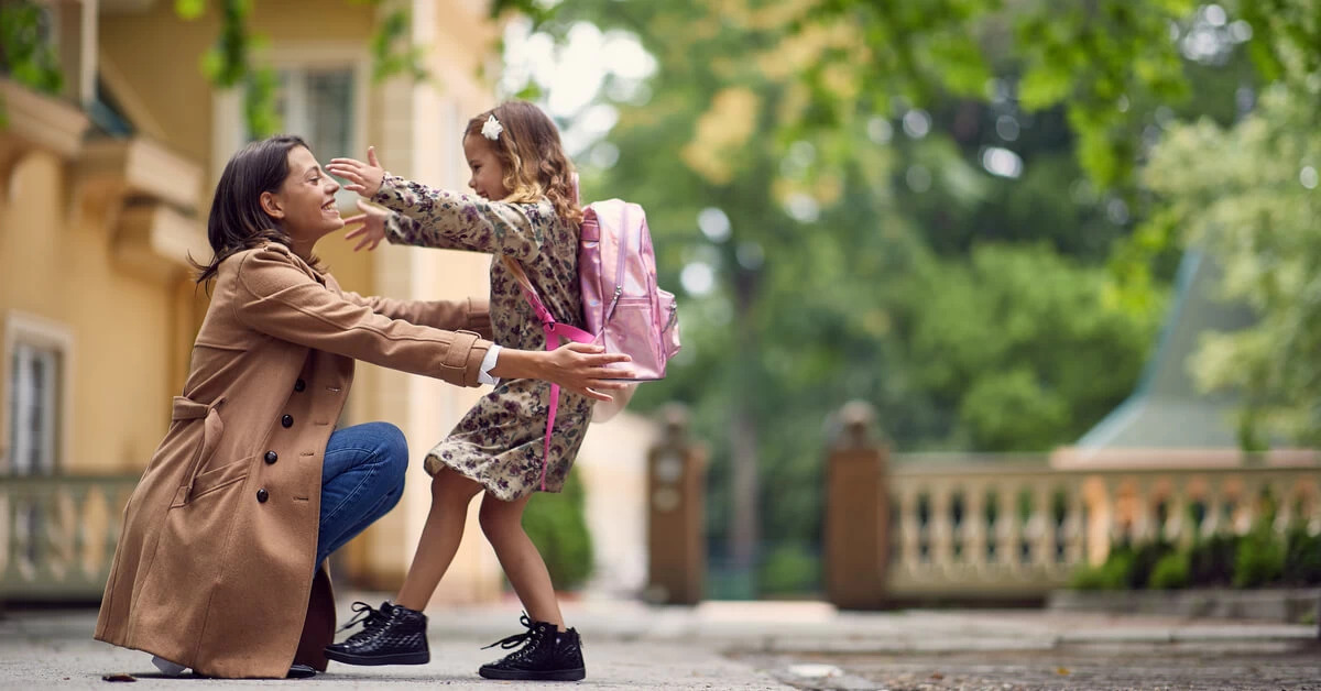 working mom hugging daughter after school