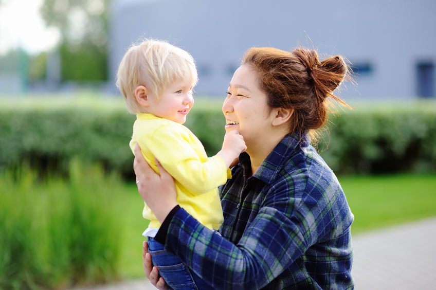 nanny, kids, checking nanny references, outside, blond, yellow, blue, grass, happy