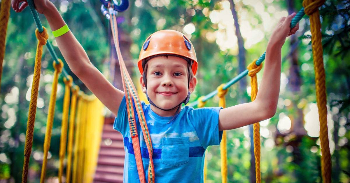 boy enjoying the challenges of summer camp
